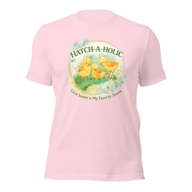 Pink t-shirt featuring "Hatch-a-holic" text and cute yellow chicks on a grassy background.