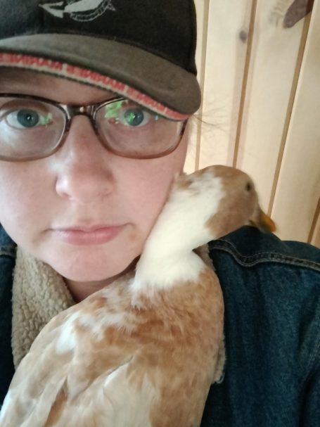 woman snuggling with duck